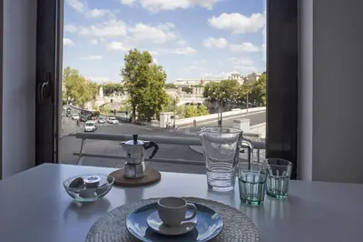 a table with a tea pot and glasses on a balcony at BigFamilyRome - Sistine Chapel in Rome