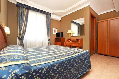 a hotel room with a bed and a window at Hotel Rimini in Rome