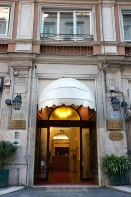 an entrance to a building with a white awning at Hotel Rimini in Rome