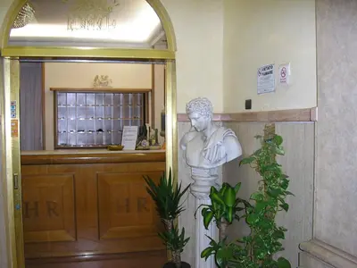 a statue of a man standing next to a door at Hotel Rimini in Rome
