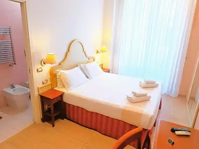 a hotel room with a bed and a bathroom at Roman Terrace in Rome