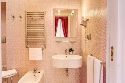 a bathroom with a sink and a mirror at Roman Terrace in Rome