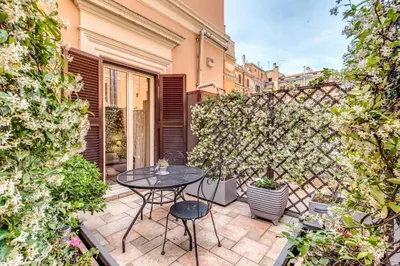a patio with a table and chairs in a courtyard at Roman Terrace in Rome