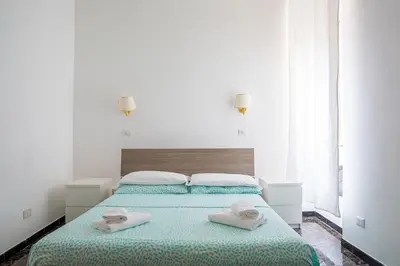 a bedroom with a bed with two towels on it at Hotel Castelfidardo in Rome