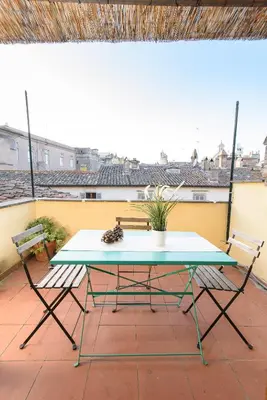 a table and two chairs on a patio at White terrace apartment navona in Rome