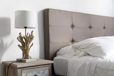 a bed with a lamp on a night stand next to a bed at White terrace apartment navona in Rome