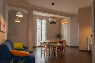 a living room with a table and a blue couch at La Terrazza di Evelina Guest House in Rome