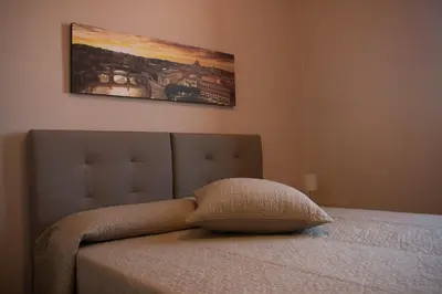 a pillow sitting on top of a bed in a bedroom at La Terrazza di Evelina Guest House in Rome