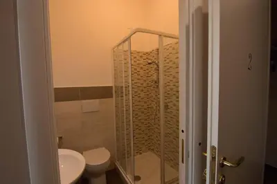 a bathroom with a shower with a toilet and a sink at La Terrazza di Evelina Guest House in Rome