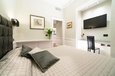 a bedroom with a bed and a flat screen tv at Le Stanze Di Federica in Rome