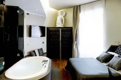 a bedroom with a bed and a tub in it at Le Stanze Di Federica in Rome
