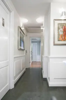 a hallway with white walls and a painting on the wall at Le Stanze Di Federica in Rome