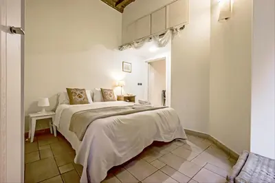 a white bedroom with a large bed in a room at GuestHost - Palazzo Farnese Historical Home in Rome