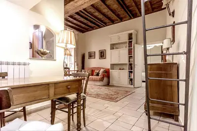 a home office with a desk and a living room at GuestHost - Palazzo Farnese Historical Home in Rome