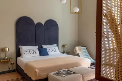 a bedroom with a large bed with a blue headboard at Glance in Rome in Rome