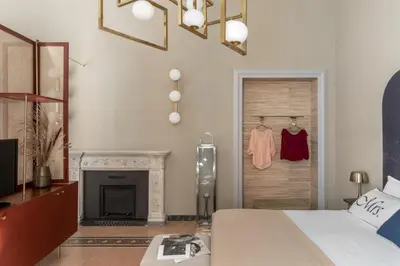 a bedroom with a bed and a fireplace and a door at Glance in Rome in Rome
