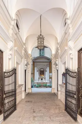 a hallway in a building with a chandelier at Glance in Rome in Rome