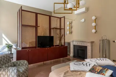 a living room with a tv and a fireplace at Glance in Rome in Rome