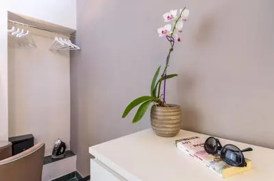 a plant in a vase sitting on top of a table at Trastevere Sweet House in Rome