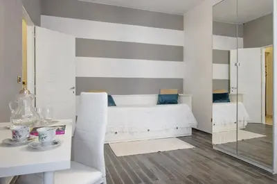 a bedroom with a bed and a table and a mirror at Trastevere Sweet House in Rome