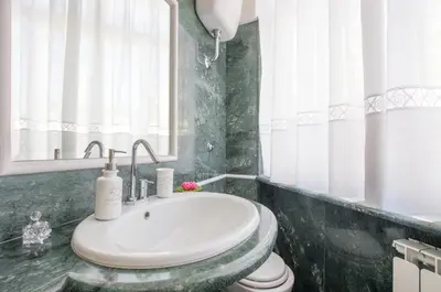 a bathroom with a sink and a toilet at Trastevere Sweet House in Rome