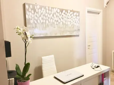 a white desk with a laptop and a flower on it at Trastevere Sweet House in Rome