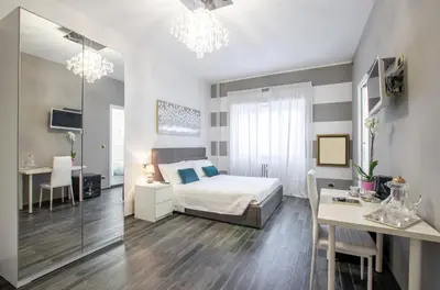 a bedroom with a bed and a table and a desk at Trastevere Sweet House in Rome