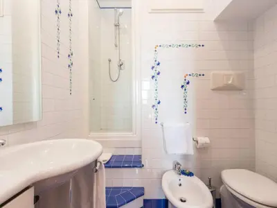 a white bathroom with a sink and a toilet at TREVI luxury with terrace in Rome