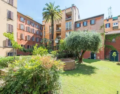 a courtyard of an apartment building with trees and bushes at TREVI luxury with terrace in Rome