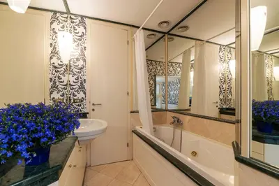 a bathroom with a sink and a tub and a mirror at Piazza di Spagna 90 Exclusive Apartment in Rome