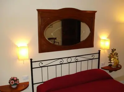 a bedroom with a large mirror above a bed at B&B La Casa Di Rosy in Rome