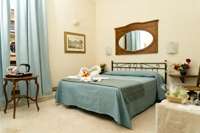 a bedroom with a bed with a mirror and a table at B&B La Casa Di Rosy in Rome