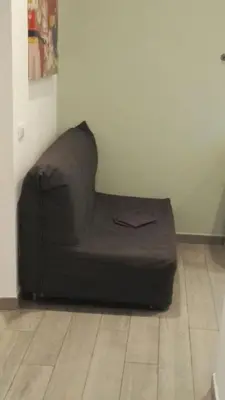 a couch sitting in the corner of a room at Sweet home Appio Latino in Rome