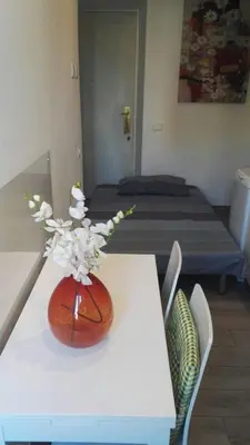a white table with a vase of flowers on it at Sweet home Appio Latino in Rome