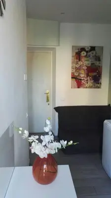 a vase with white flowers on a table in a room at Sweet home Appio Latino in Rome