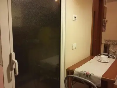 a room with a table and a glass door at Monolocale Monteverde in Rome