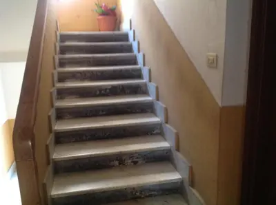 a staircase in a building with a stair case at Monolocale Monteverde in Rome