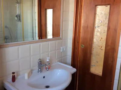 a bathroom with a sink and a mirror at Monolocale Monteverde in Rome