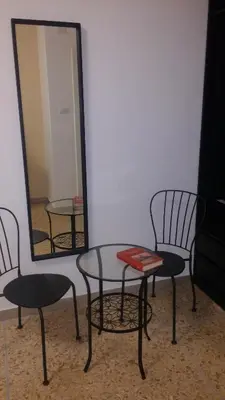 a table and two chairs and a mirror at Casa Giramondo in Rome