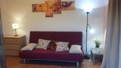 a couch with pillows on it in a living room at Casa Giramondo in Rome