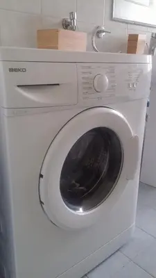 a white washing machine sitting in a kitchen at Casa Giramondo in Rome