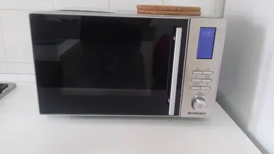 a microwave oven sitting on a white counter at Casa Giramondo in Rome