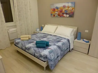 a bedroom with a large bed with blue pillows at Stephen Accommodation in Rome