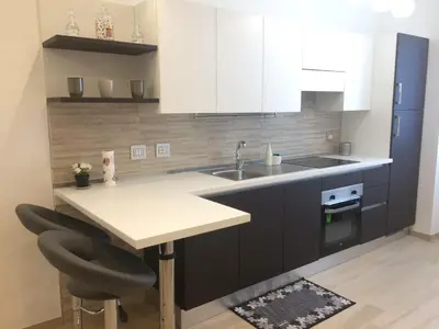 a kitchen with white cabinets and a sink and a counter at Stephen Accommodation in Rome