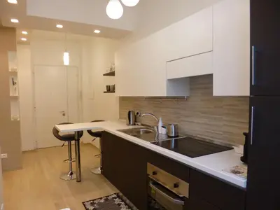 a kitchen with a sink and a counter top at Stephen Accommodation in Rome