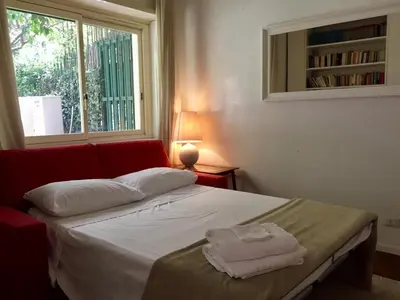 a bedroom with a bed with white sheets and a window at Cadlolo Luxury Retreat - Rome Cavalieri and Villa Miani in Rome