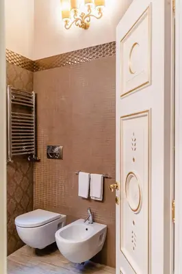a bathroom with a white toilet and a sink at Locanda Del Sole-Roma Piazza Di Spagna Ripetta in Rome