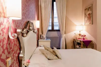 a bedroom with a bed with two pillows on it at Locanda Del Sole-Roma Piazza Di Spagna Ripetta in Rome