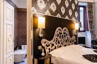 a bedroom with a bed and a tub and a sink at Locanda Del Sole-Roma Piazza Di Spagna Ripetta in Rome