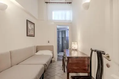 a living room with a couch and a table at Appartamento Trevi Vicolo Scanderbeg in Rome